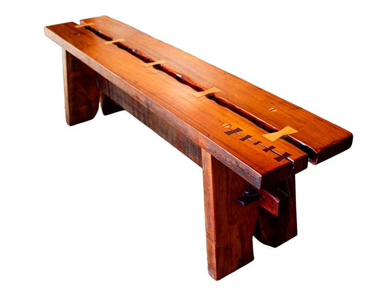 Mahogany Bench with a split top held together with maple bowties. A crack at the end of the bench has Purple Heart bowties.
