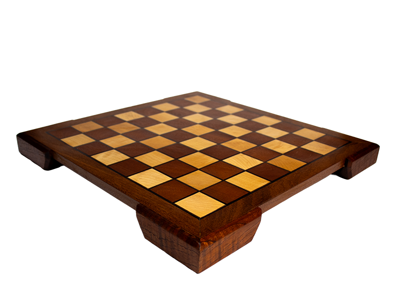 Chessboard made from Mahogany and Hard Maple with an Ipe border and Spanish Cedar feet and black resin lines, diagonal edge view.