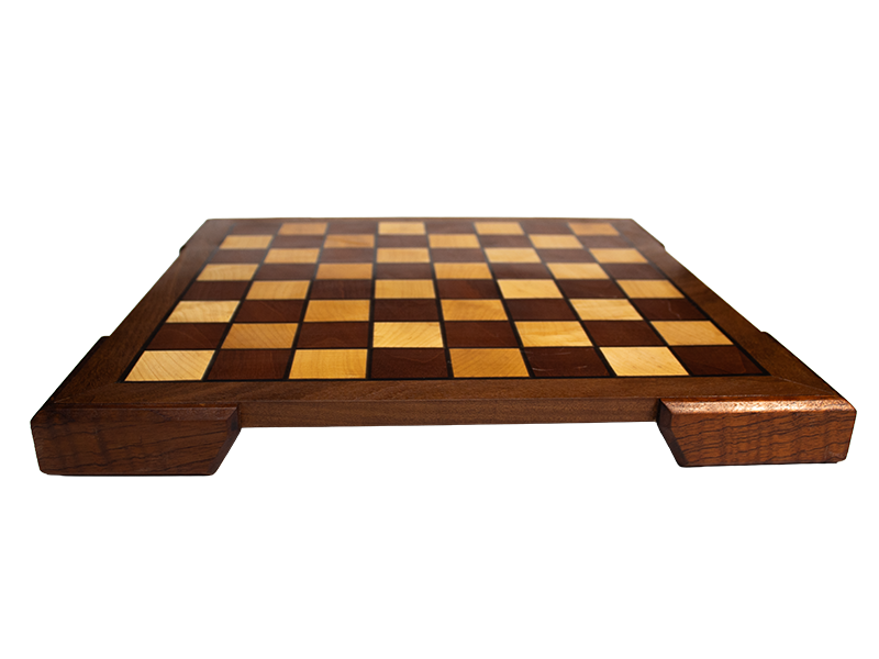 Chessboard made from Mahogany and Hard Maple with an Ipe border and Spanish Cedar feet and black resin lines, side view.